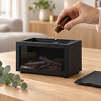 Ajout d'une goutte d'huile essentielle dans le réservoir de l'humidificateur